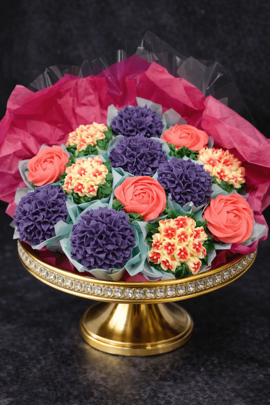 Cupcake bouquet with purple, coral, and yellow buttercream flowers
